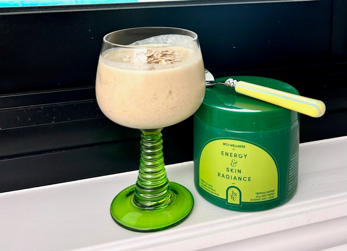oatmeal smoothie on bench with INTU WELLNESS tub of Energy & Skin Radiance