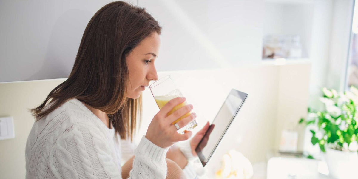 Woman drinking INTU WELLNESS Super Powders