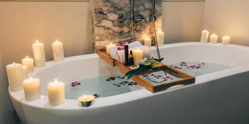 Bathtub with candles and bath table