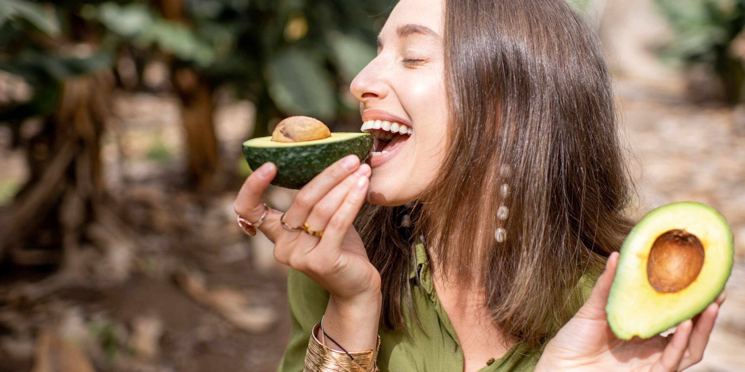 Healthy foods for skin, girl eating avocado